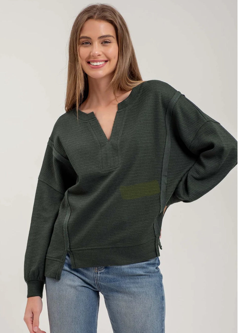 SPLIT NECK EXPOSED SEAM LONG SLEEVE KNIT TOP