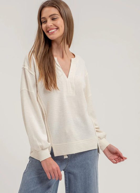 SPLIT NECK EXPOSED SEAM LONG SLEEVE KNIT TOP